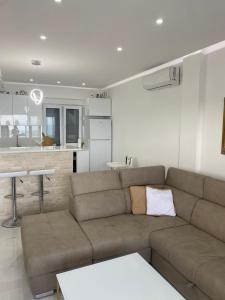 a living room with a couch and a kitchen at Vini Apartments in Zagrađe