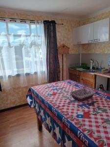 uma cozinha com uma mesa com uma toalha de mesa xadrez em Lenga em Punta Arenas