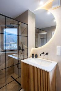 a bathroom with a sink and a mirror at CASA IL TRAMONTO Val di Sole in Commezzadura +89 photos