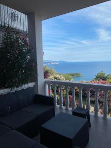 a balcony with a bench and a view of the ocean at Vini Apartments in Zagrađe