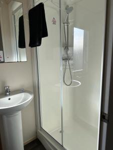 a bathroom with a shower and a sink at Beautiful 3 bed Caravan in Felixstowe in Felixstowe