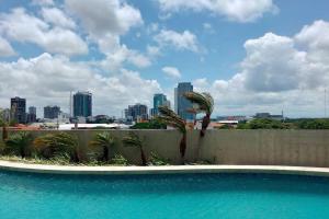 a swimming pool with a city skyline in the background at Hermoso departamento Curupaú Isuto in Santa Cruz de la Sierra