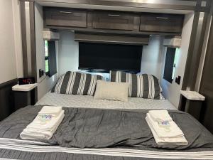 a bedroom with a large bed in a rv at The Magic Motor Home in Parkland