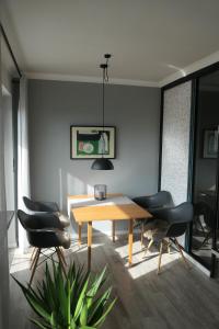 a dining room with a wooden table and chairs at SchönHier in Westerburg