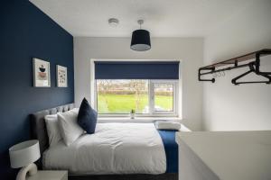 a bedroom with a bed and a window at Renvyle House By Horizon Stays in Stockton-on-Tees