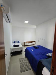 a room with two beds and a door to a bedroom at Ap barra grande com piscina in Marau +17 photos