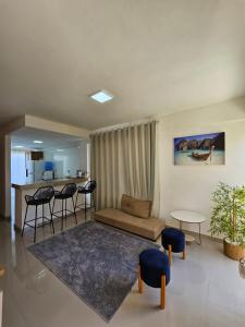 a living room with a couch and a table at Ap barra grande com piscina in Marau