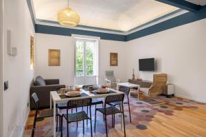 a living room with a table and chairs at Real Tenuta Apartments By Domus Sicily in Palermo