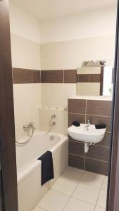 a bathroom with a sink and a toilet and a tub and a sink at Lux Cordia Apartment with free parking in Budapest +80 photos
