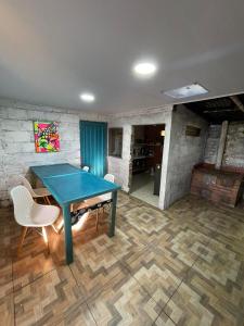 a dining room with a blue table and chairs at Vista hermosa in Anserma