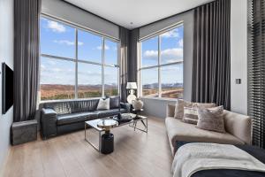 a living room with a couch and large windows at Luxurious large home Perfect for your group in Hafnarfjörður