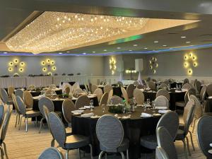 a banquet hall with tables and chairs and lights at Lakeview Golf Resort in Morgantown +91 photos
