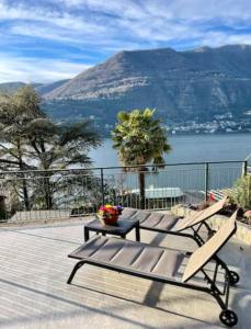 a patio with two benches and a view of the water at La Casa della Bruna, wonderful lake view & parking in Blevio