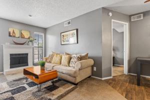 a living room with a couch and a fireplace at Urban One Bedroom Apartment with Wifi in Dallas