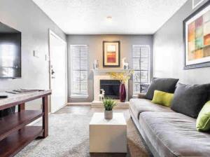 a living room with a couch and a fireplace at Affordable Apartment with Balcony in Dallas