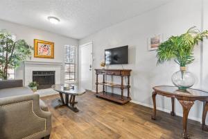 a living room with a couch and a fireplace at Extended Stay Affordable in North Dallas in Dallas