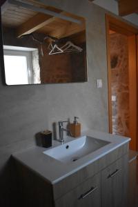 a bathroom with a white sink and a mirror at Casa de Celebrar a Vida in Monchique