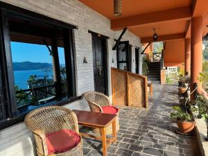 a patio with wicker chairs and a wooden table at Nar-Bis Hotel in Pokhara