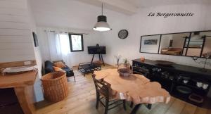 een woonkamer met een tafel en een eetkamer bij La Bergeronnette in Queyrac