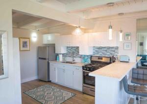 a kitchen with a refrigerator and a counter top at STUNNINGLY PERFECT Beach ALL NEW REMODEL Galore in Laguna Beach
