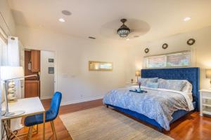 a bedroom with a blue bed and a table and chairs at Stunning huge one level 1350 ft. cottage in Mission Viejo
