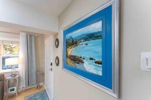 a painting hanging on a wall in a room at STUNNING HOME 4 MIN WALK TO BEACH, RESERVED PRKG in Laguna Beach