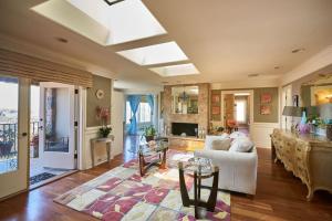 a living room with a couch and a table at UNEQUALLED LUXURY VILLA BEACH 7000ft 180 VIEW in Laguna Beach