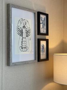 a picture of a drawing on a wall with pictures at Stones Throw Lodge in Padstow