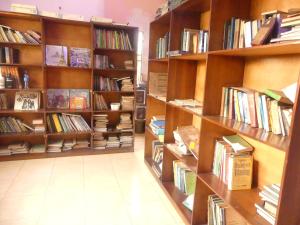 a library with wooden shelves filled with books at Templar's Court in Port Harcourt