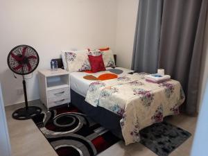 a small bedroom with a bed and a fan at TOP VIEW LUXURY APARTMENT in Centurion