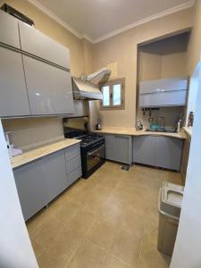 a large kitchen with white cabinets and a sink at Villa in hurghada in Hurghada