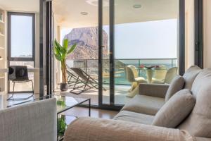 a living room with a couch and a table at Apartamento Bernia al Mar 8A by Costa CarpeDiem in Calpe
