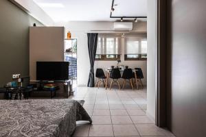 a living room with a television and a dining room at Dantis Place in Nafplio wheel chair accessible in Nafplio