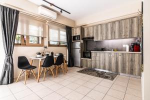 a kitchen with a table and chairs in a room at Dantis Place in Nafplio wheel chair accessible in Nafplio