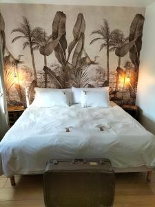 a bedroom with a bed with a suitcase on it at La Mouillère in Verton