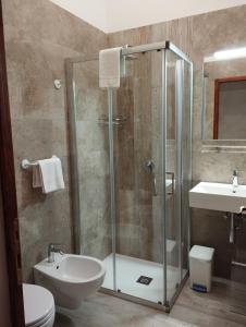 y baño con ducha, aseo y lavamanos. en Rocca degli Olivi, en San Gimignano