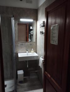 a bathroom with a sink and a mirror and a shower at Rocca degli Olivi in San Gimignano