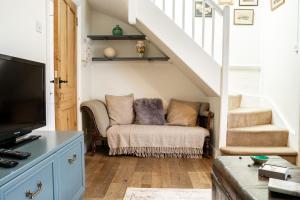 a living room with a couch and a tv at Historical 2 bed cottage - Chester centre - For 4 in Chester