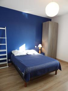 - une chambre bleue dotée d'un lit avec un mur bleu dans l'établissement Spacieuse villa a St Cyprien pour 15, à Saint-Cyprien