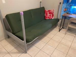 a green couch in a room with a table at Best Value inside City Miami, Near Airport, Beach, Center & Metro in Miami