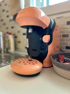 an orange and black mixer sitting on a counter at Airport Residence in Otopeni