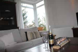 a bottle of champagne on a table in a living room at Villa Elsa in Durbuy