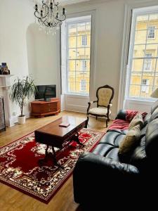 a living room with a couch and a coffee table at Charming Apartment in the Heart of Bath in Bath