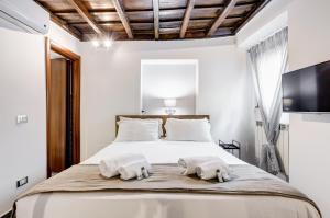 a bedroom with a bed with towels on it at Chiavari Apartment in Rome