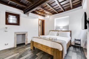 a bedroom with a large bed and a fireplace at Chiavari Apartment in Rome