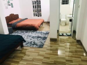 a room with two beds and a bathroom at Cyan Sapa Homestay in Sapa