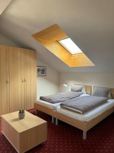 a bedroom with a large bed and a skylight at Hotel Residence in Grindelwald