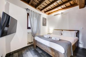 a bedroom with a large bed and a tv at Chiavari Apartment in Rome
