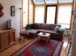 a living room with a couch and a table at Apartmenthaus Kometerhof in Flattach