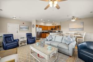 a living room with a couch and a table at SP301S - Endless Summer in Kill Devil Hills